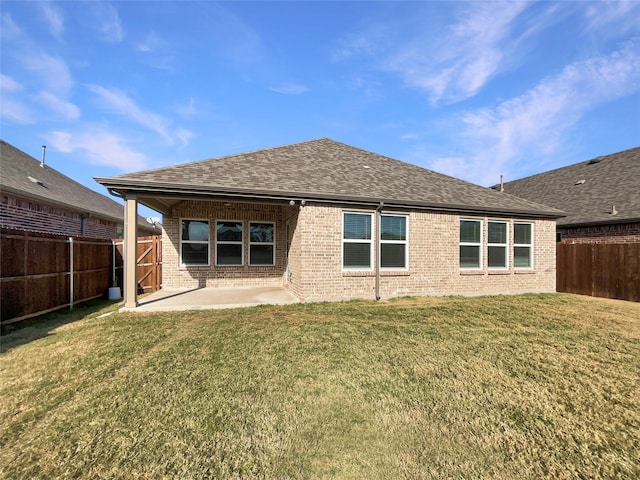 back of property with a yard and a patio area