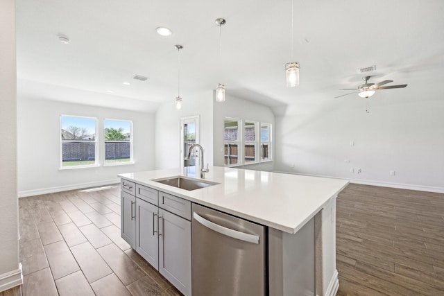 kitchen with open floor plan, stainless steel dishwasher, a sink, and visible vents