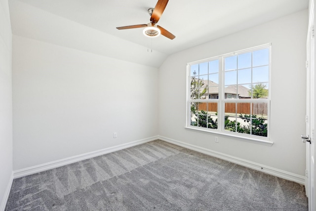 unfurnished room featuring baseboards, a ceiling fan, lofted ceiling, and carpet floors