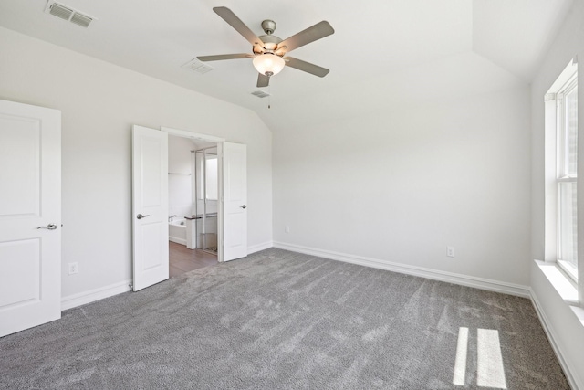 unfurnished bedroom with visible vents, baseboards, vaulted ceiling, and carpet floors