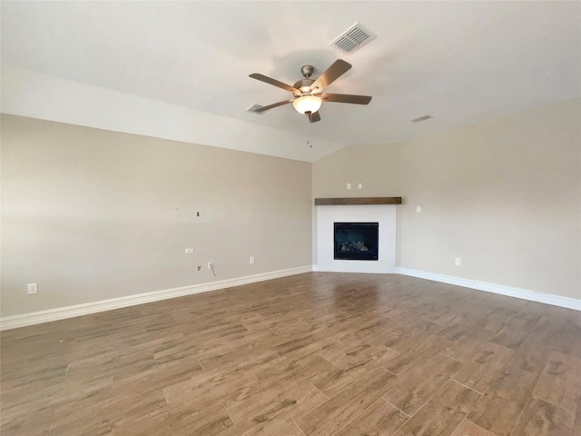 unfurnished living room featuring hardwood / wood-style flooring, ceiling fan, and lofted ceiling