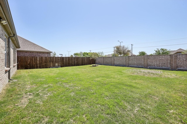 view of yard featuring a fenced backyard