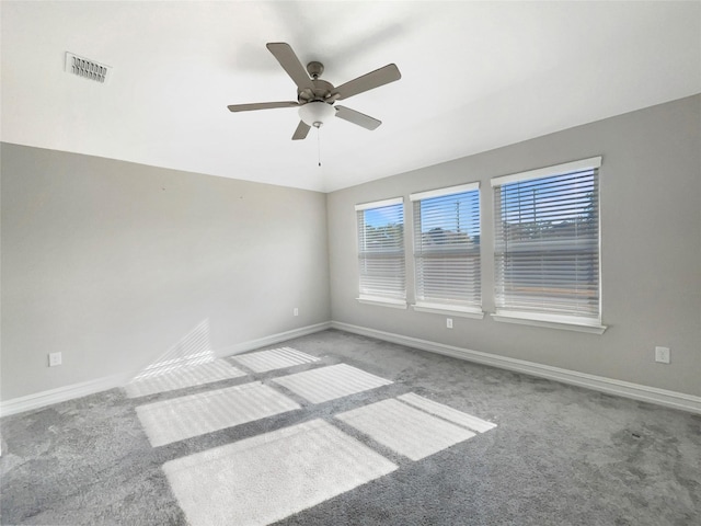 spare room with ceiling fan and carpet