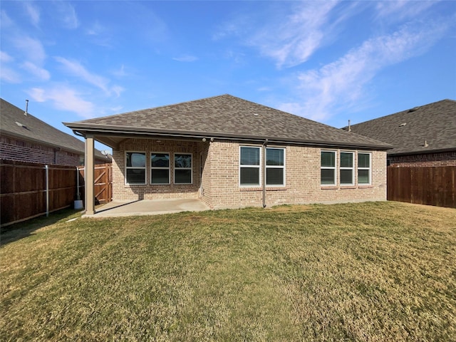 rear view of property featuring a yard and a patio area