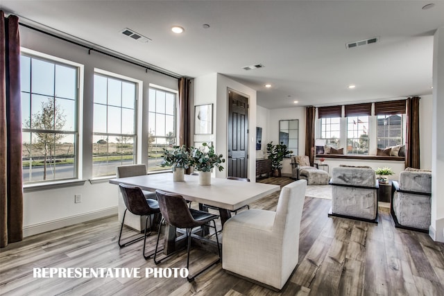 dining area featuring hardwood / wood-style flooring and plenty of natural light