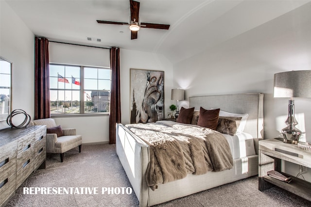 carpeted bedroom featuring ceiling fan and vaulted ceiling