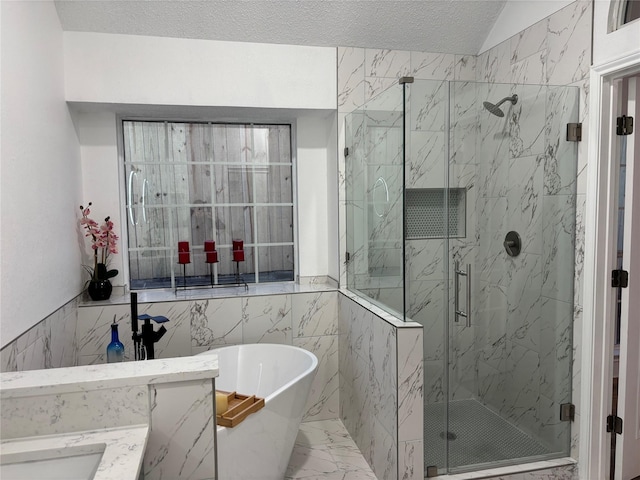 bathroom with a textured ceiling, vanity, and tile walls