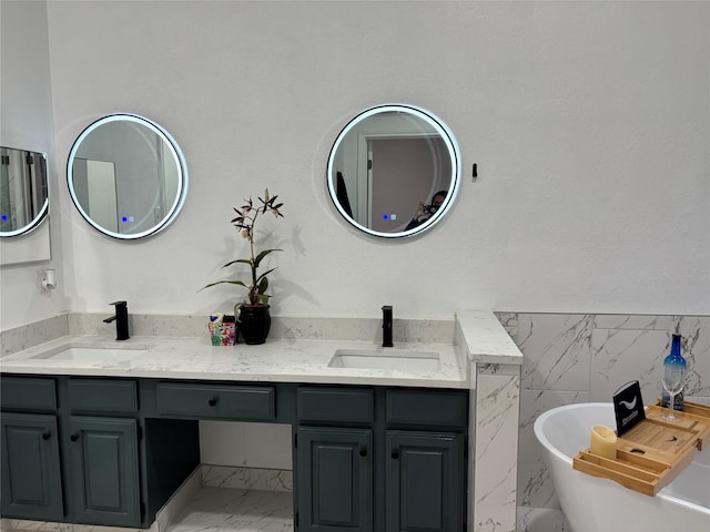 bathroom featuring a bath, vanity, and tile walls