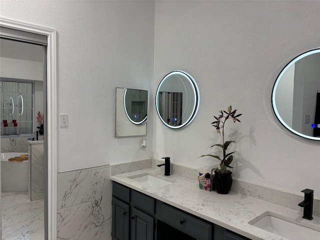 bathroom featuring vanity and a tub