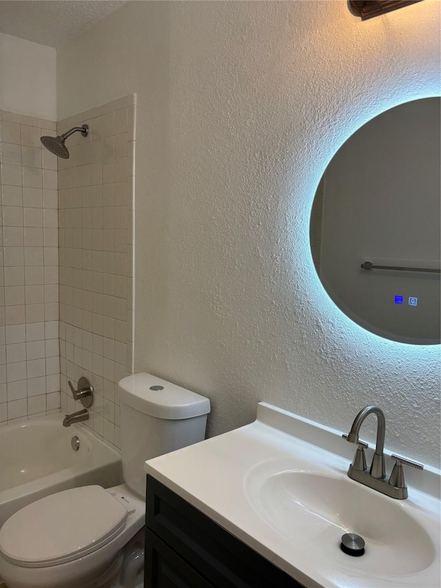 full bathroom featuring vanity, toilet, and tiled shower / bath