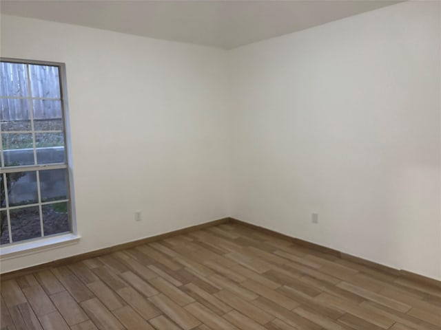 unfurnished room with wood-type flooring