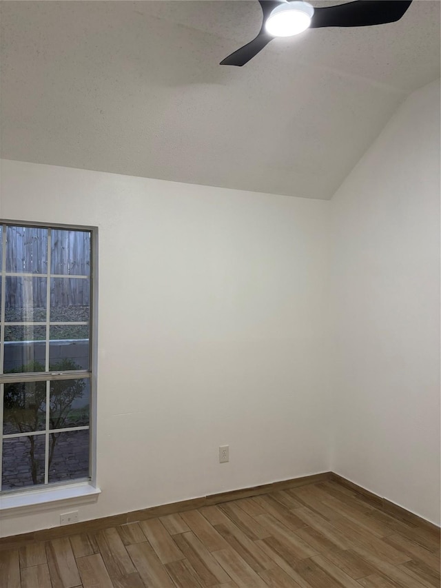 unfurnished room featuring lofted ceiling and wood-type flooring