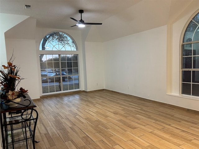 interior space with ceiling fan, light wood-type flooring, and vaulted ceiling