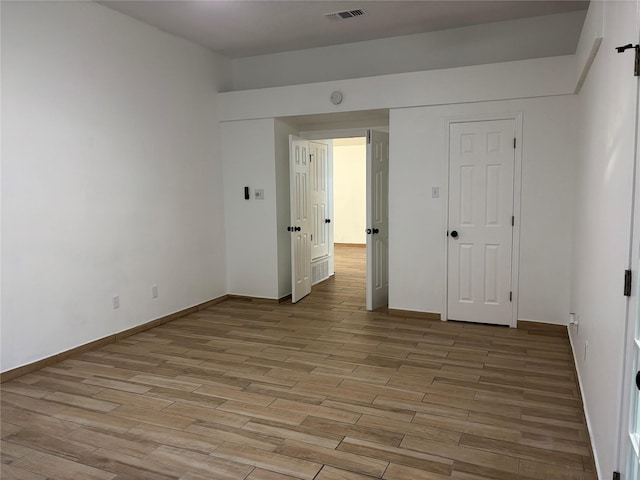 unfurnished room with light hardwood / wood-style floors