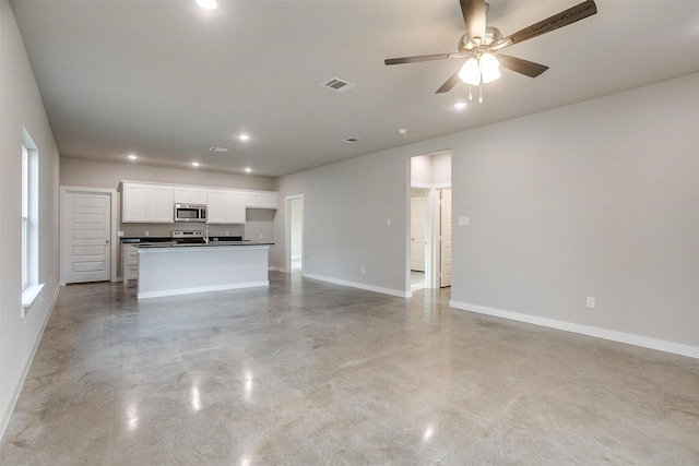 unfurnished living room featuring ceiling fan