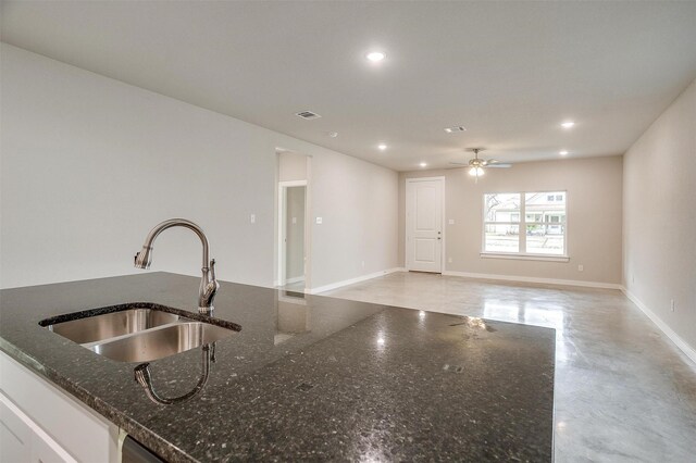 kitchen with white cabinets, dishwasher, sink, a kitchen island with sink, and ceiling fan