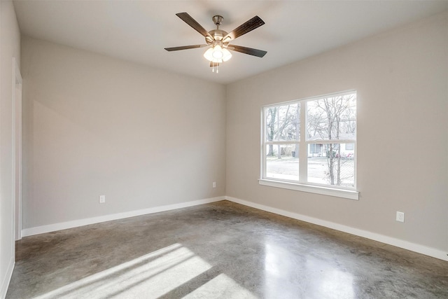 spare room featuring ceiling fan and concrete flooring