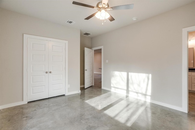 unfurnished bedroom with ceiling fan, a closet, and ensuite bathroom