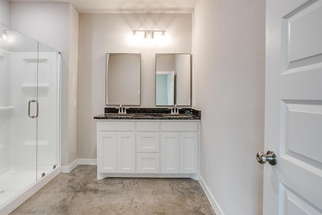 bathroom featuring a shower with door, vanity, and concrete floors