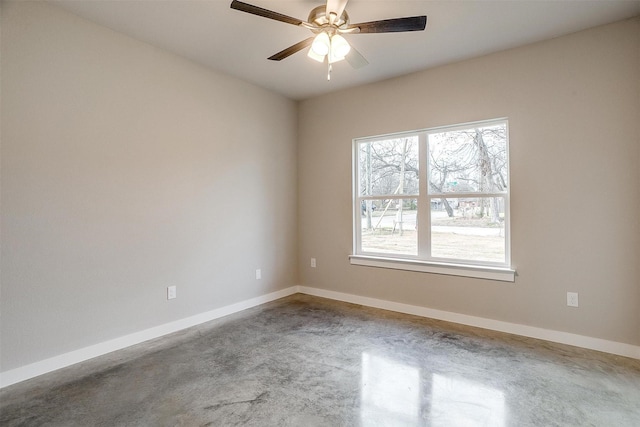 unfurnished room with ceiling fan and concrete floors