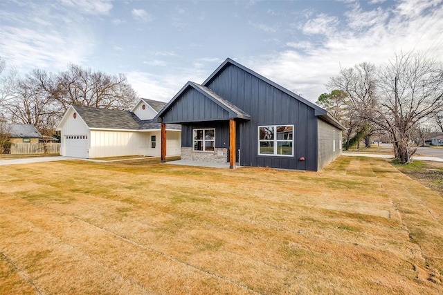 view of front of home with a front lawn and a garage