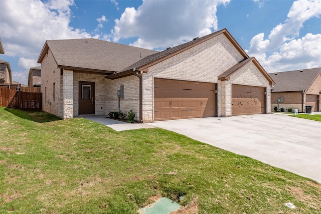 view of front of property with a garage and a front lawn