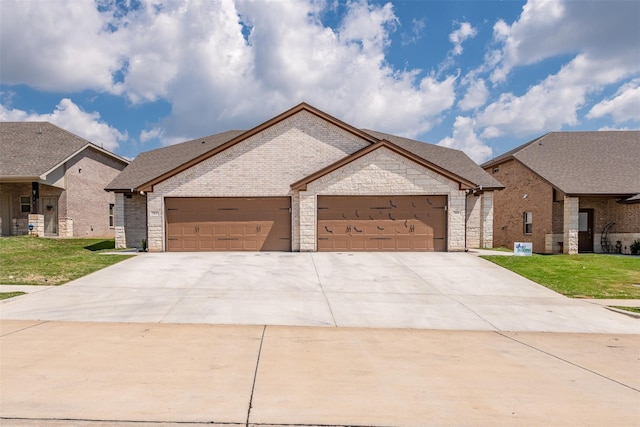 view of front of house with a front yard and a garage