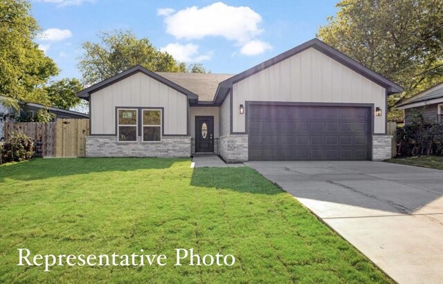 view of front of house with a garage and a front lawn