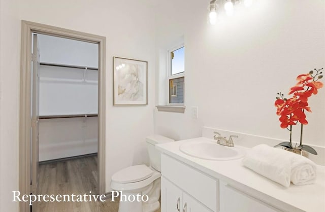 bathroom featuring hardwood / wood-style floors, vanity, and toilet