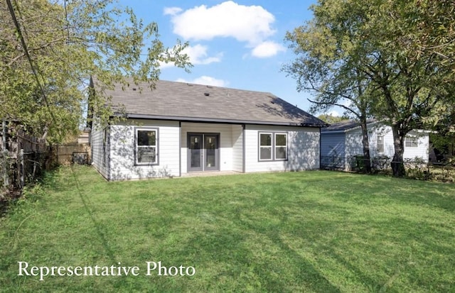 rear view of property with a yard