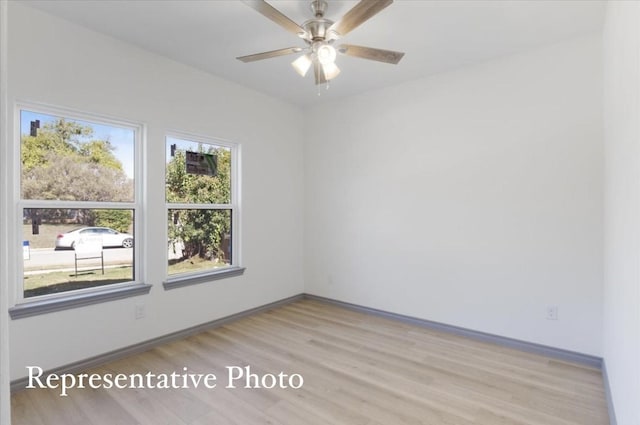 empty room with light wood-type flooring and ceiling fan