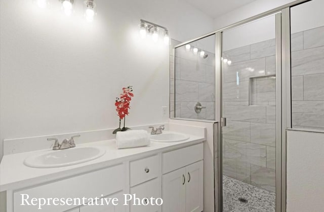 bathroom featuring vanity and a shower with shower door