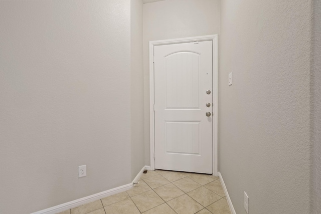 doorway to outside featuring light tile patterned floors