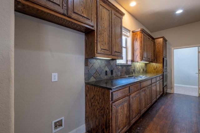 kitchen with tasteful backsplash, dark hardwood / wood-style floors, and stovetop