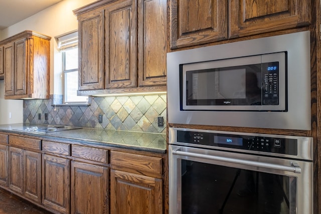 kitchen with appliances with stainless steel finishes and tasteful backsplash