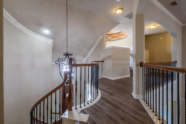 staircase featuring crown molding and hardwood / wood-style floors