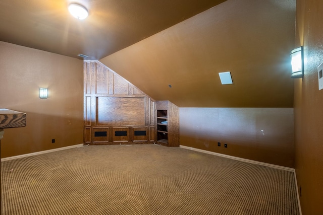 additional living space featuring carpet flooring and vaulted ceiling