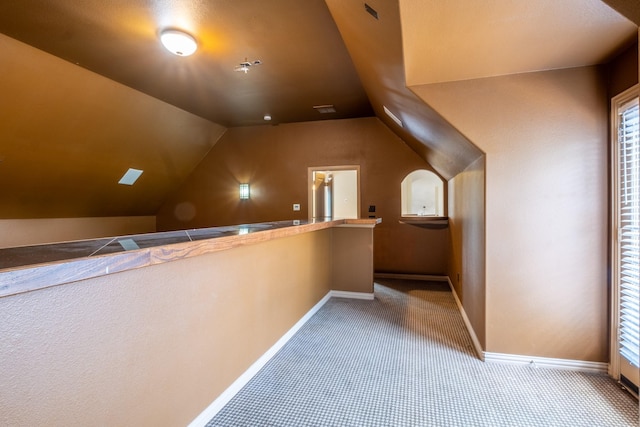 bonus room featuring carpet flooring and vaulted ceiling