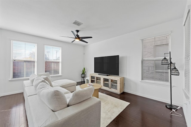 living room with dark hardwood / wood-style floors and ceiling fan