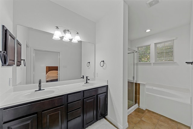 bathroom with tile patterned floors, vanity, and separate shower and tub