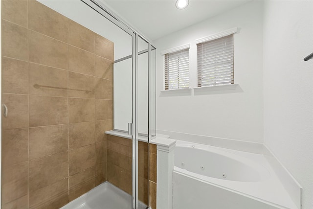 bathroom featuring shower with separate bathtub