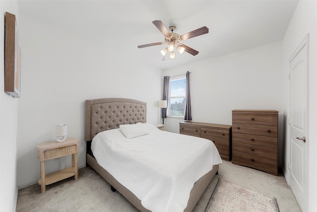 bedroom featuring ceiling fan and light carpet