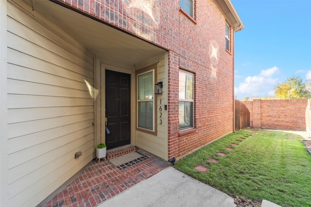 property entrance with a yard