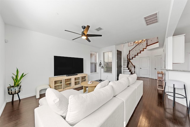 living room featuring ceiling fan and dark hardwood / wood-style flooring