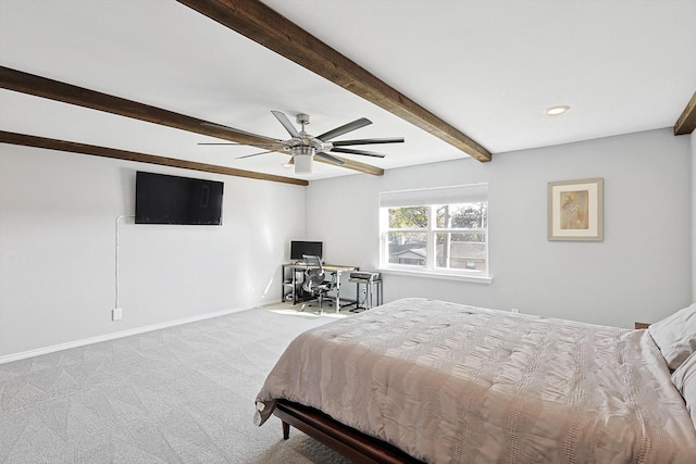 carpeted bedroom featuring beamed ceiling and ceiling fan