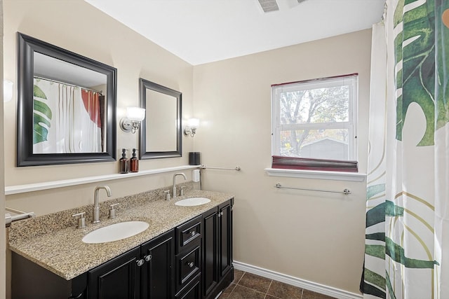 bathroom with tile patterned flooring and vanity