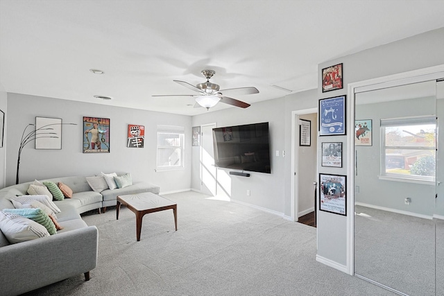 carpeted living room with ceiling fan and a wealth of natural light