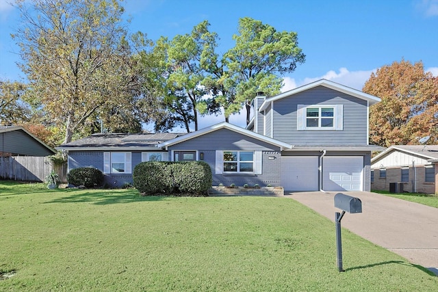 view of front facade with a garage, central air condition unit, and a front lawn