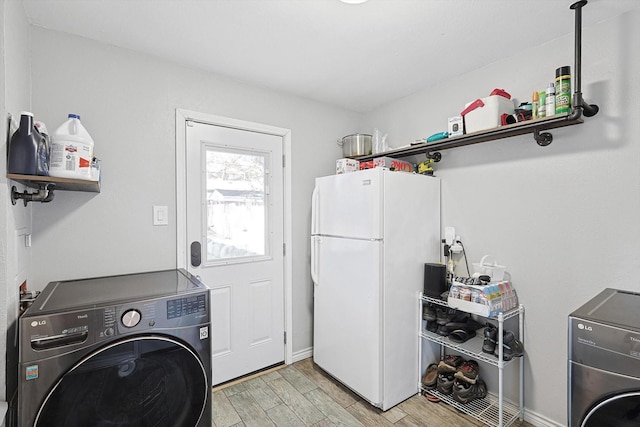 laundry area featuring washer / clothes dryer and light hardwood / wood-style flooring