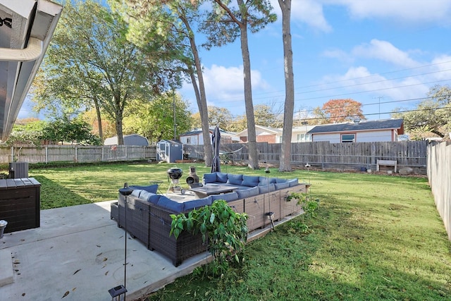 view of yard featuring outdoor lounge area, a patio area, and a storage unit